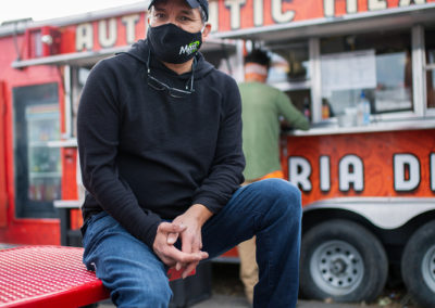 small business owner smiling in front of food truck