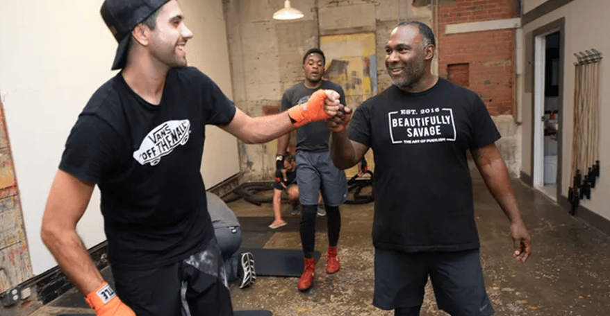 Men high fiving in boxing gym